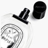 Diptyque L’Eau Papier Eau de Toilette (100 ml) - product shown laying on its side with lid off.