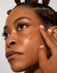 Odacite SPF 50 Flex-Perfecting™ Mineral Drops Tinted Sunscreen - Model shown applying product to face