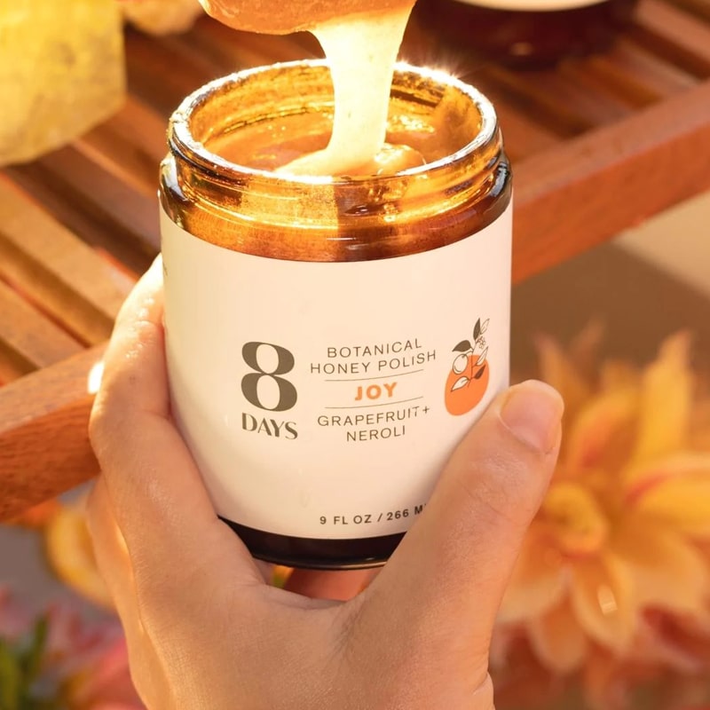8 Days Botanicals Joy Honey Body Polish - Model shown holding product in hand
