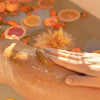 8 Days Botanicals Joy Honey Body Polish - Model shown applying product to leg