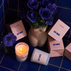 ROEN Candles Bar Monti Scented Candle - Beauty shot product shown next to flowers in vase