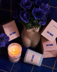 ROEN Candles Bar Monti Scented Candle - Beauty shot product shown next to flowers in vase