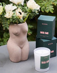 ROEN Candles Hotel Flori Scented Candle - Beauty shot product shown next to flowers in vase
