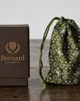 Bernard Parfum Meli Roll On Parfum Ol Bijou - Product displayed on wood table with cloth and packaging