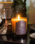 Bernard Parfum Cleome Candle - Product displayed on wood table lifestyle photo