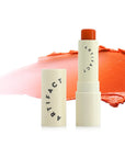 Artifact Soft Sail Blurring Tinted Lip Balm - Persimmon's Luck 10 g showing open tube with color swatch in background