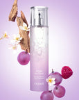 Lifestyle shot of Caudalie Ange des Vignes Light Fragrance (50 ml) with grapes, raspberry, flowers and bark in the background
