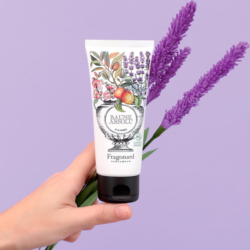 Absolute Balm - Lavender - Hand holding product with lavender in the background