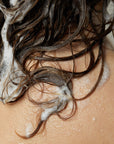 Roz Foundation Shampoo - Model shown with product lathered in hair