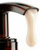 A close-up of Nuxe Reve de Miel Ultra-Comforting Body Cream pump dispenser showing body cream dispensing from pump