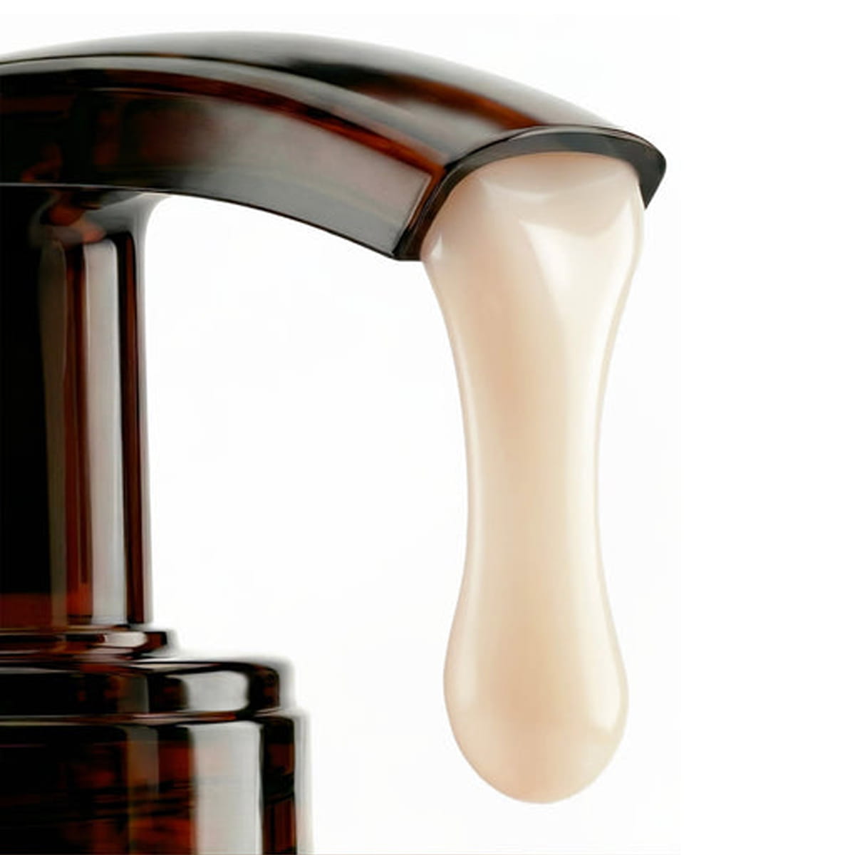 A close-up of Nuxe Reve de Miel Ultra-Comforting Body Cream pump dispenser showing body cream dispensing from pump