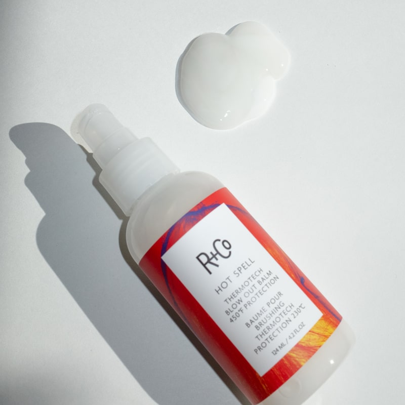 R+Co Hot Spell Thermotech Blowout Balm - Product shown next to product droplet