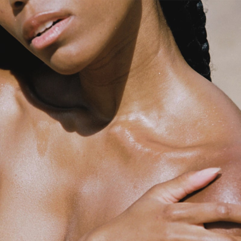 FORAH Dayglow Oil Serum - Models chest shown with product applied