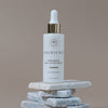 Innersense Organic Beauty Hair Renew Daily Active Serum - product shown on a rock. 
