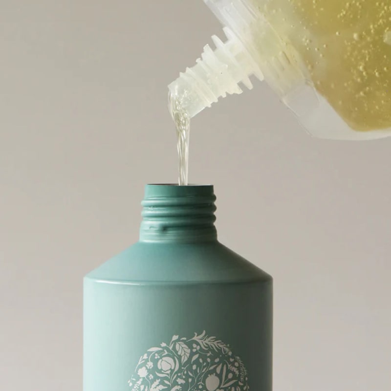 Roz Foundation Shampoo (600 ml Refill) - Product shown being poured into bottle