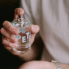 Kerzon Fragranced Mist - Petit Grain (100 ml) - product shown being sprayed by model.