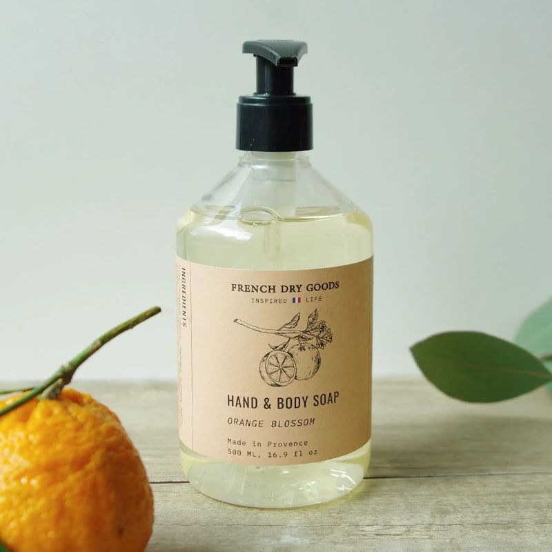 French Dry Goods Hand & Body Soap – Orange Blossom - Product displayed on wood table with orange