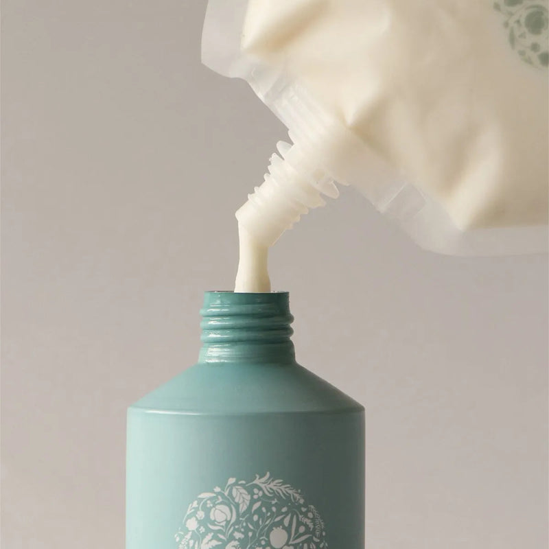 Roz Foundation Conditioner (600 ml Refill) - Product shown being poured into bottle
