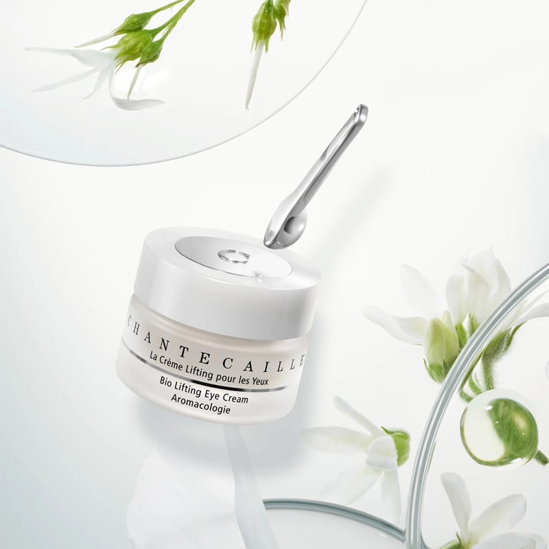 Chantecaille Bio Lifting Eye Cream - lifestyle photo of packaging, spoon, plants, and glass circles