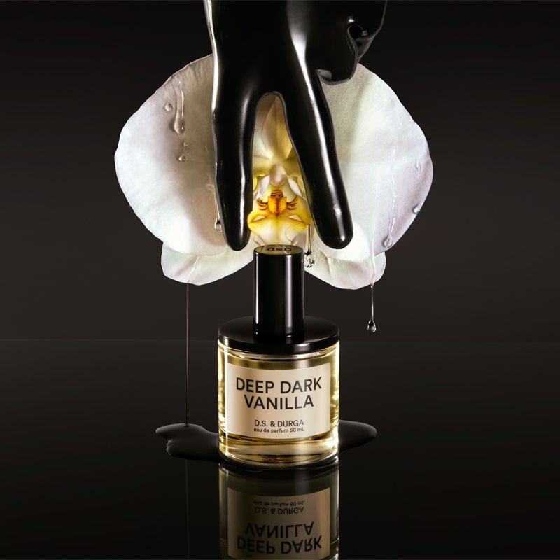 D.S. &amp; Durga Deep Dark Vanilla Eau de Parfum - bottle, orchid, and black gloved hand lifestyle shot