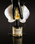 D.S. & Durga Deep Dark Vanilla Eau de Parfum - bottle, orchid, and black gloved hand lifestyle shot