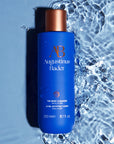 Augustinus Bader The Body Cleanser Beauty shot, product shown next to water