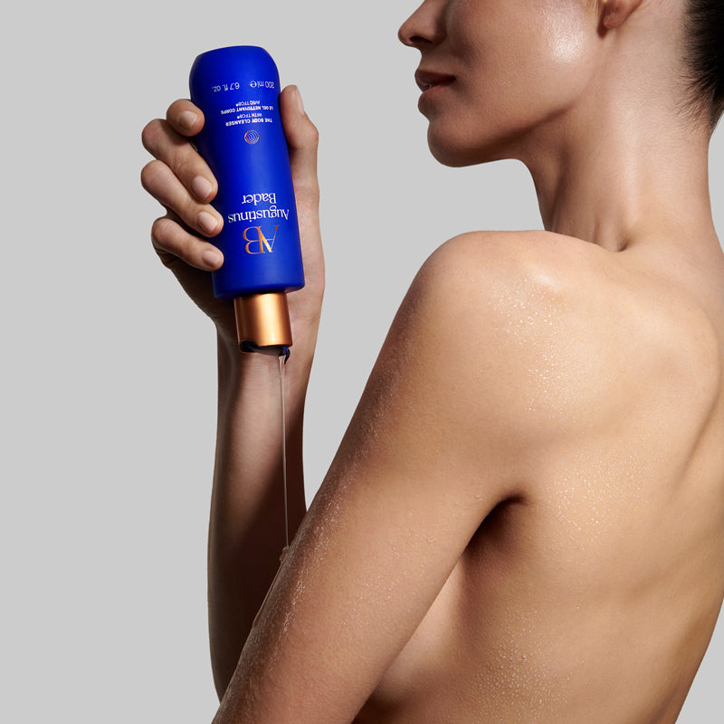 Augustinus Bader The Body Cleanser - Model shown dispensing product onto body