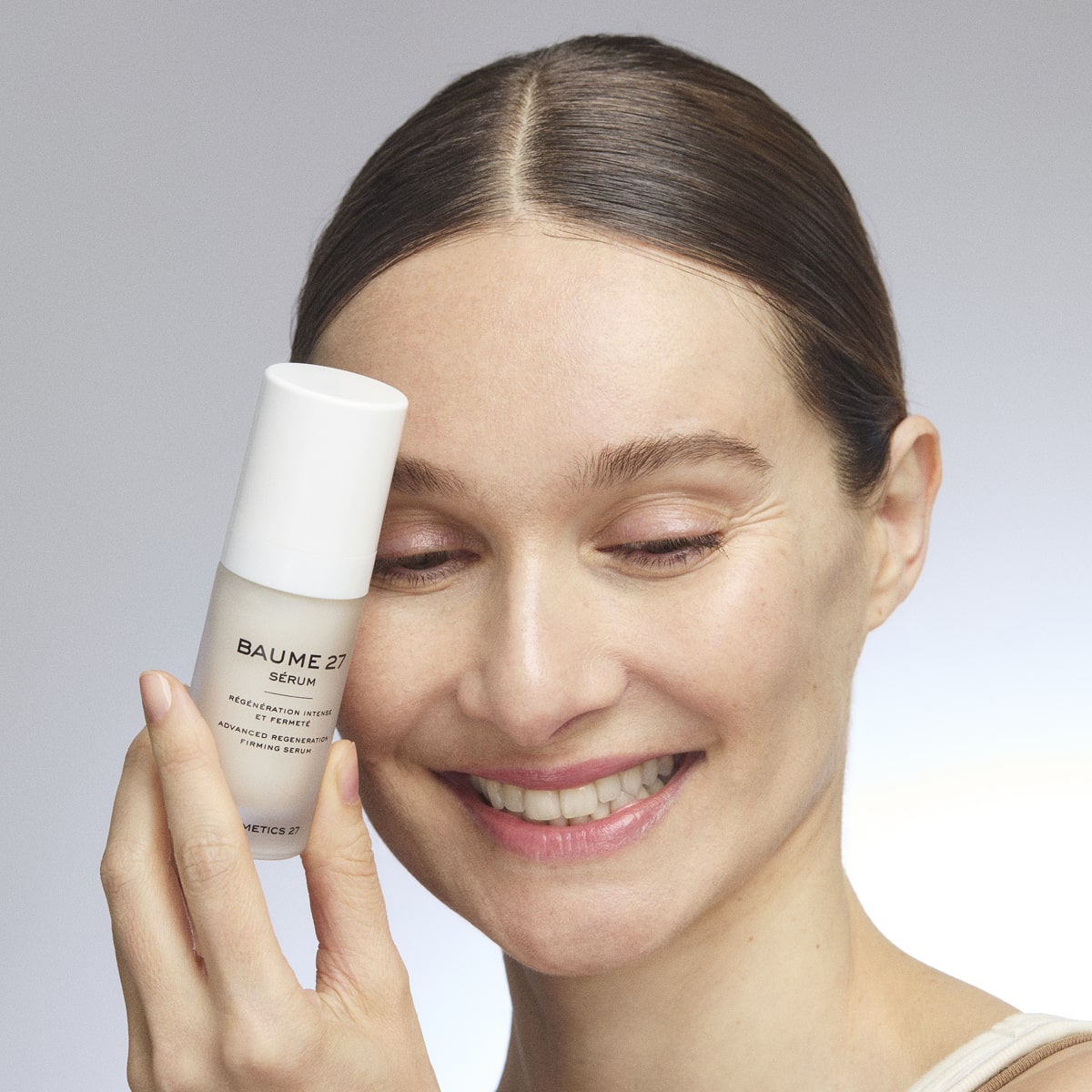 Cosmetics 27 Baume 27 Advanced Regeneration Serum (30 ml) - product shown with model. 
