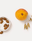 Dr. Hauschka Apricot Day Cream - almonds, apricot, and wheat on table