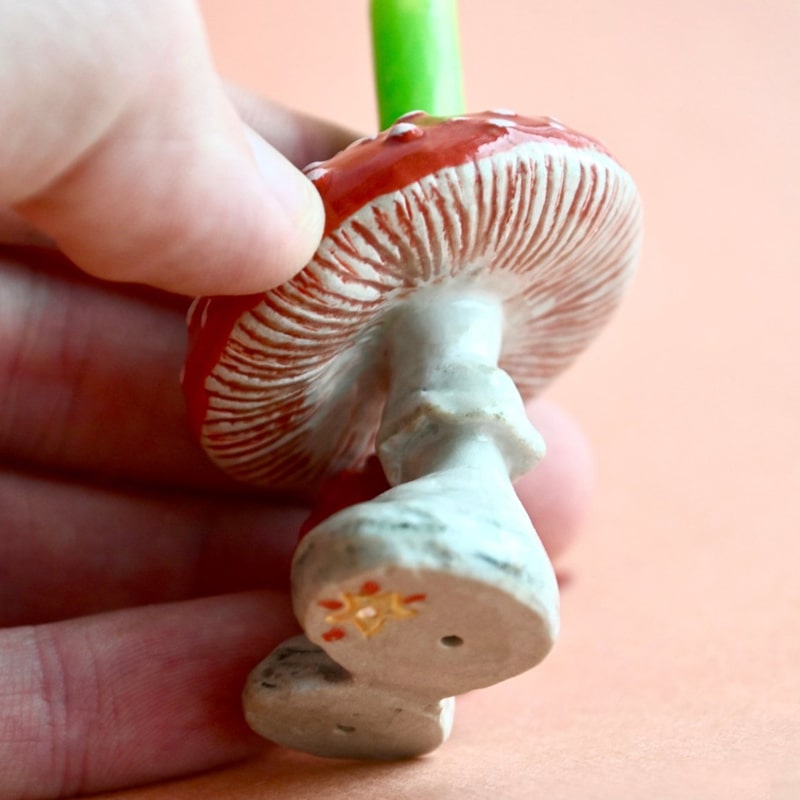 Camp Hollow Mushroom Cake Topper - Closeup of product in models hand