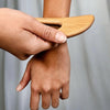 Daily Concepts Wooden Body Gua Sha Tool - Closeup of model using product on arm