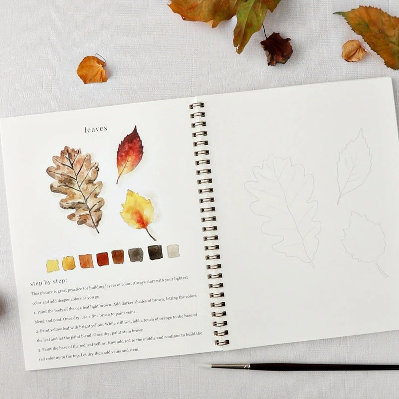 Emily Lex Studio Autumn Watercolor Workbook (1 pc) - inside of product shown with paintbrush