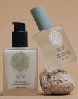 Roz The Sleek & Smooth Duo - serum and oil lifestyle shot with rock