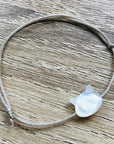 YSIE Camille Nacre Silver Bracelet Child - White Pearl Cat - Product shown on wood background