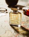 Ormonde Jayne Nawab of Oudh Intensivo Eau de Parfum - lifestyle photo of perfume bottle, glasses, passports, on map