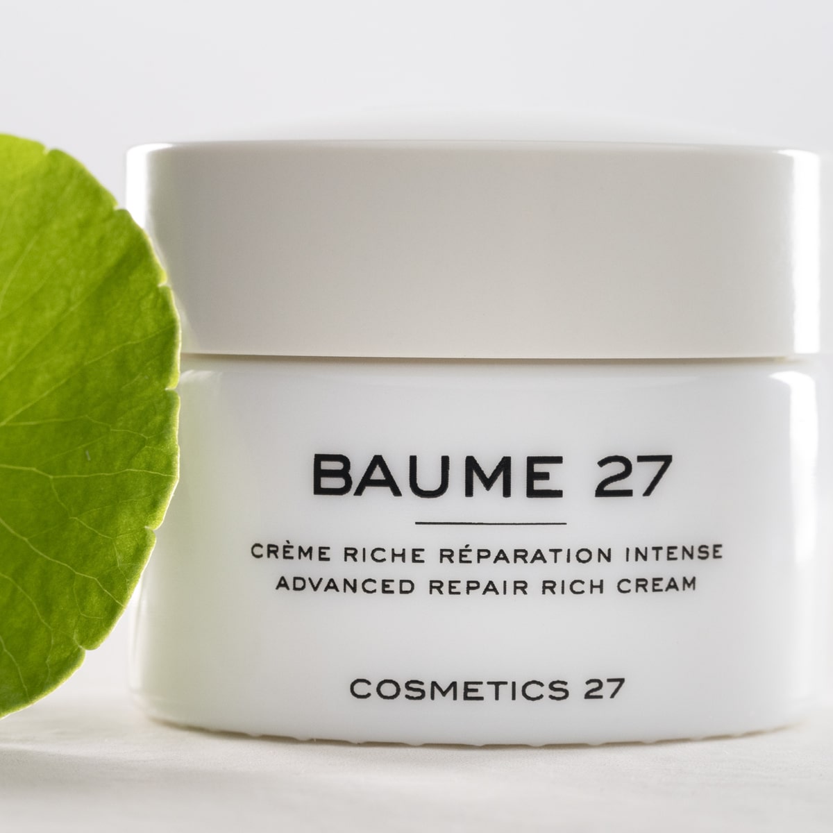 Baume 27 Advanced Formula Advanced Repair Rich Cream (50 ml) - product shown with green leaf. 