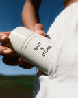Salt & Stone Neroli & Basil Deodorant - model holding product in pocket