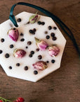 Carriere Freres Rose Pepper Botanical Palets - palet on wood table with flower