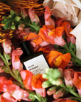 Versatile Paris Accro Disiaque Extrait de Parfum showing bottle with snapdragon flowers