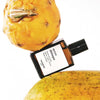 Versatile Paris Accro Disiaque Extrait de Parfum shown between other fruits