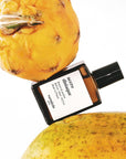 Versatile Paris Accro Disiaque Extrait de Parfum shown between other fruits