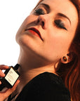 Versatile Paris Culot The (Tea Cap) Extrait de Parfum being applied to model's neck