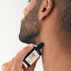 Versatile Paris Dimanche Flemme (Lazy Sunday) Extrait de Parfum being applied to neck by male model
