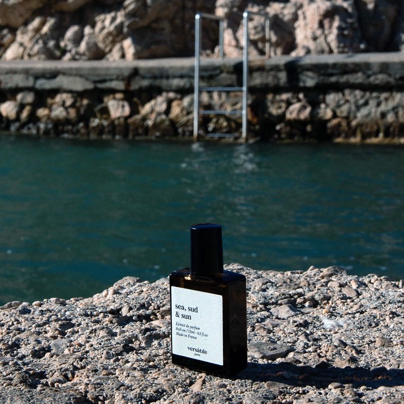 Versatile Paris Sea, Sud &amp; Sun (Sea, South &amp; Sun) Extrait de Parfum shown on rock beside swimming area