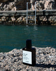 Versatile Paris Sea, Sud & Sun (Sea, South & Sun) Extrait de Parfum shown on rock beside swimming area