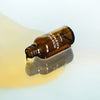 Susanne Kaufmann Face Oil - Product shown on side, pouring onto counter