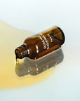 Susanne Kaufmann Face Oil - Product shown on side, pouring onto counter