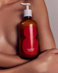 Flamingo Estate Organics Roma Heirloom Tomato Body Lotion - Model shown with product in front of chest