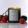 Flamingo Estate Roma Heirloom Tomato Candle (226 g) - product shown with tomatoes around it.