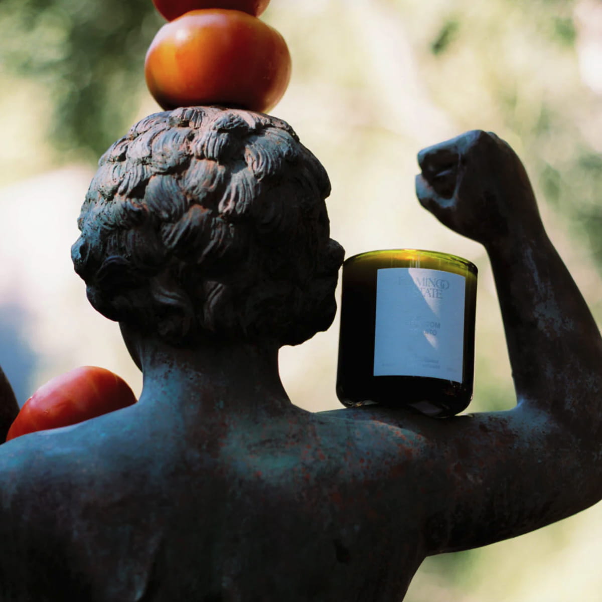 Flamingo Estate Roma Heirloom Tomato Candle (226 g) - product shown on statue. 